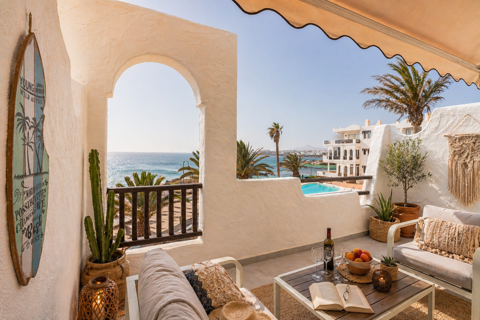 Sea-view terrace with stone arch, surfboard art and lounge seating