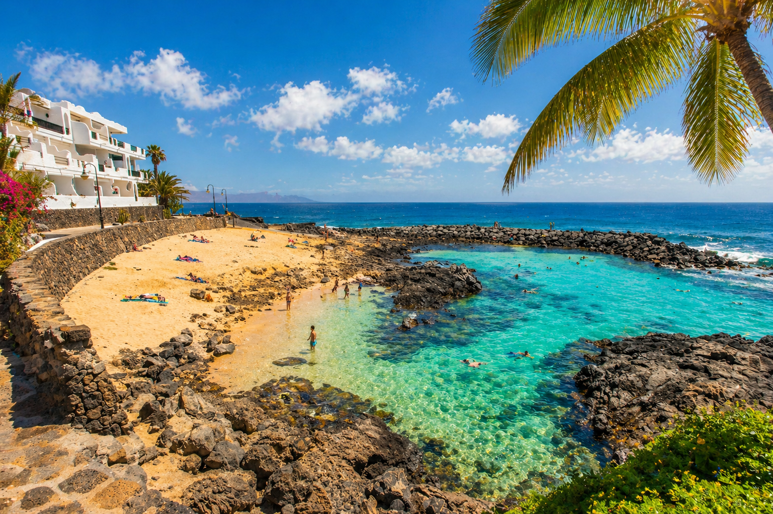 Sheltered cove and golden sand below the residence